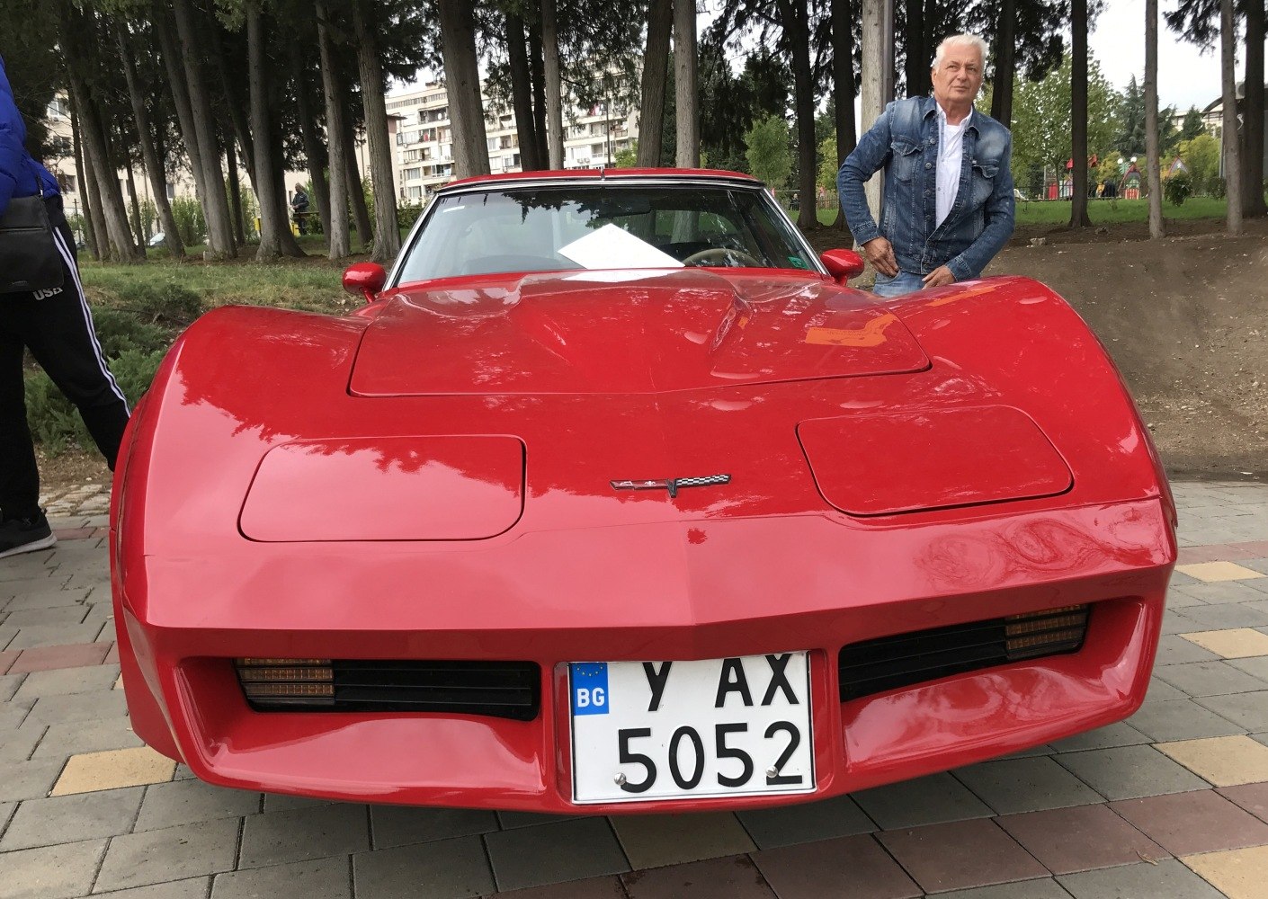 Red sports car front with pop-up headlights and smooth hood