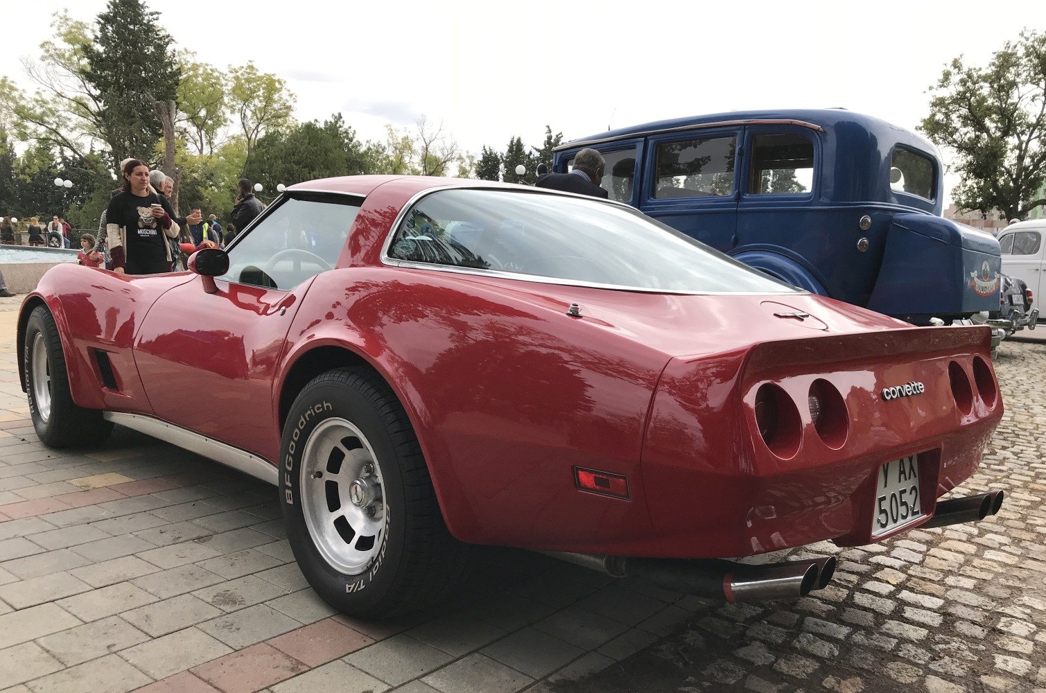 Red classic coupe rear with quad tail lights and dual exhaust pipes