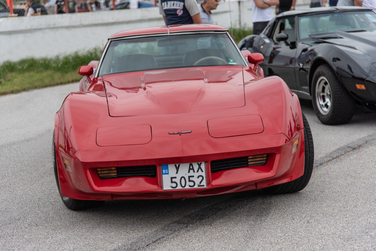Red Corvette C3 with pop-up headlights and aerodynamic hood front view