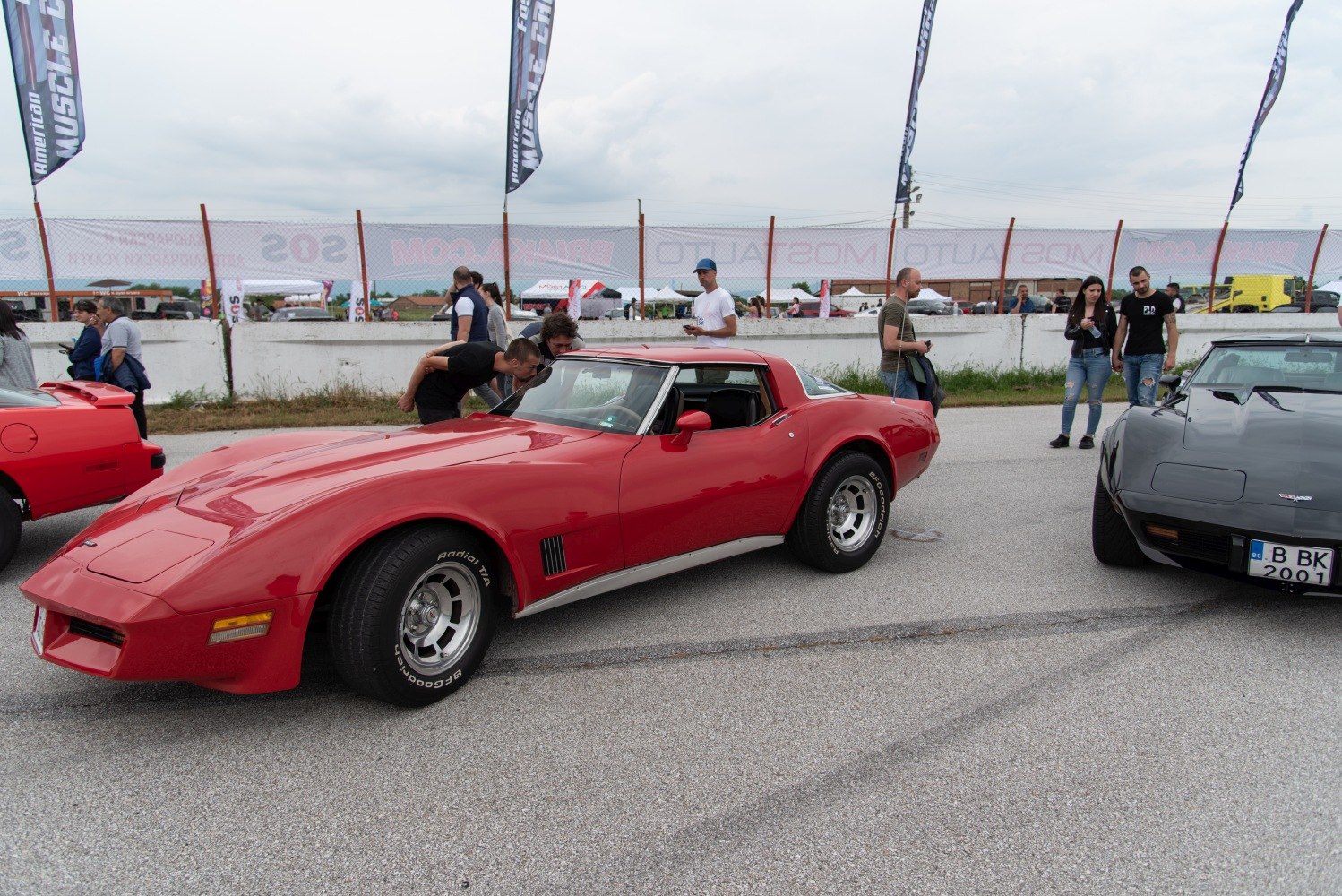 Red Corvette C3 Coupe with iconic curved body and sporty wheels