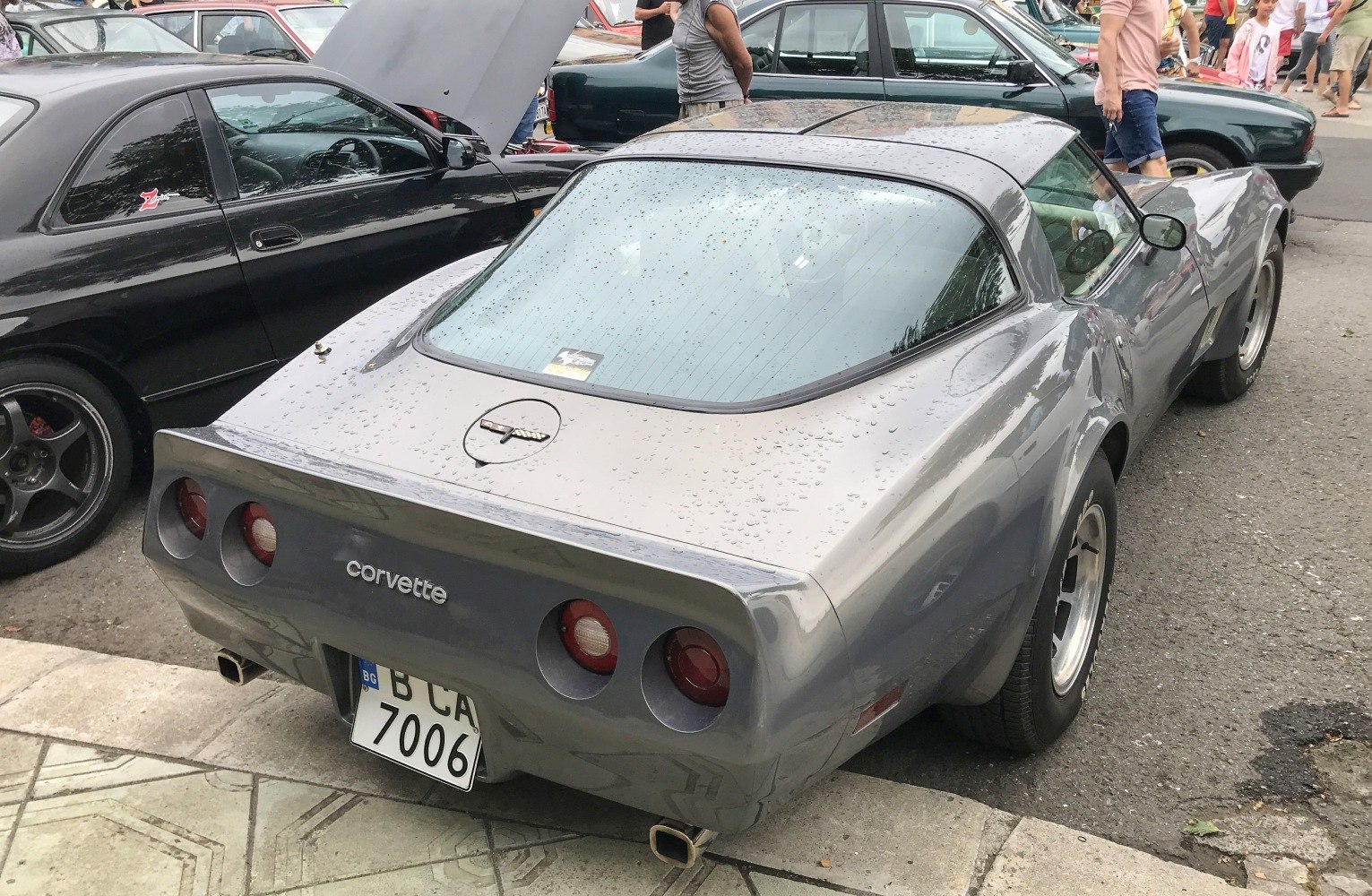 Rear view of classic coupe with quad round taillights and sleek rear window.