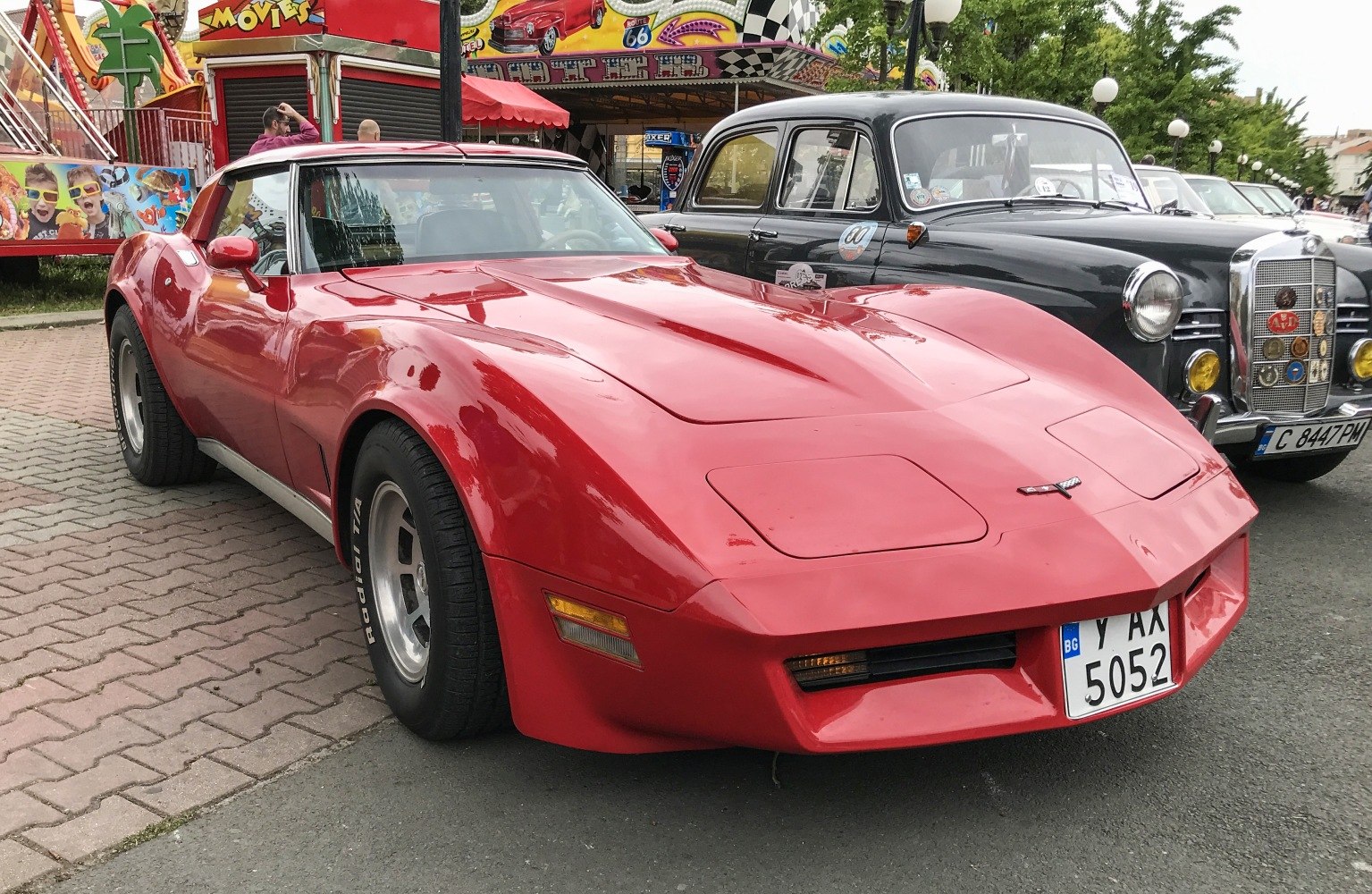 Red vintage sports coupe with popup headlights and wide tires