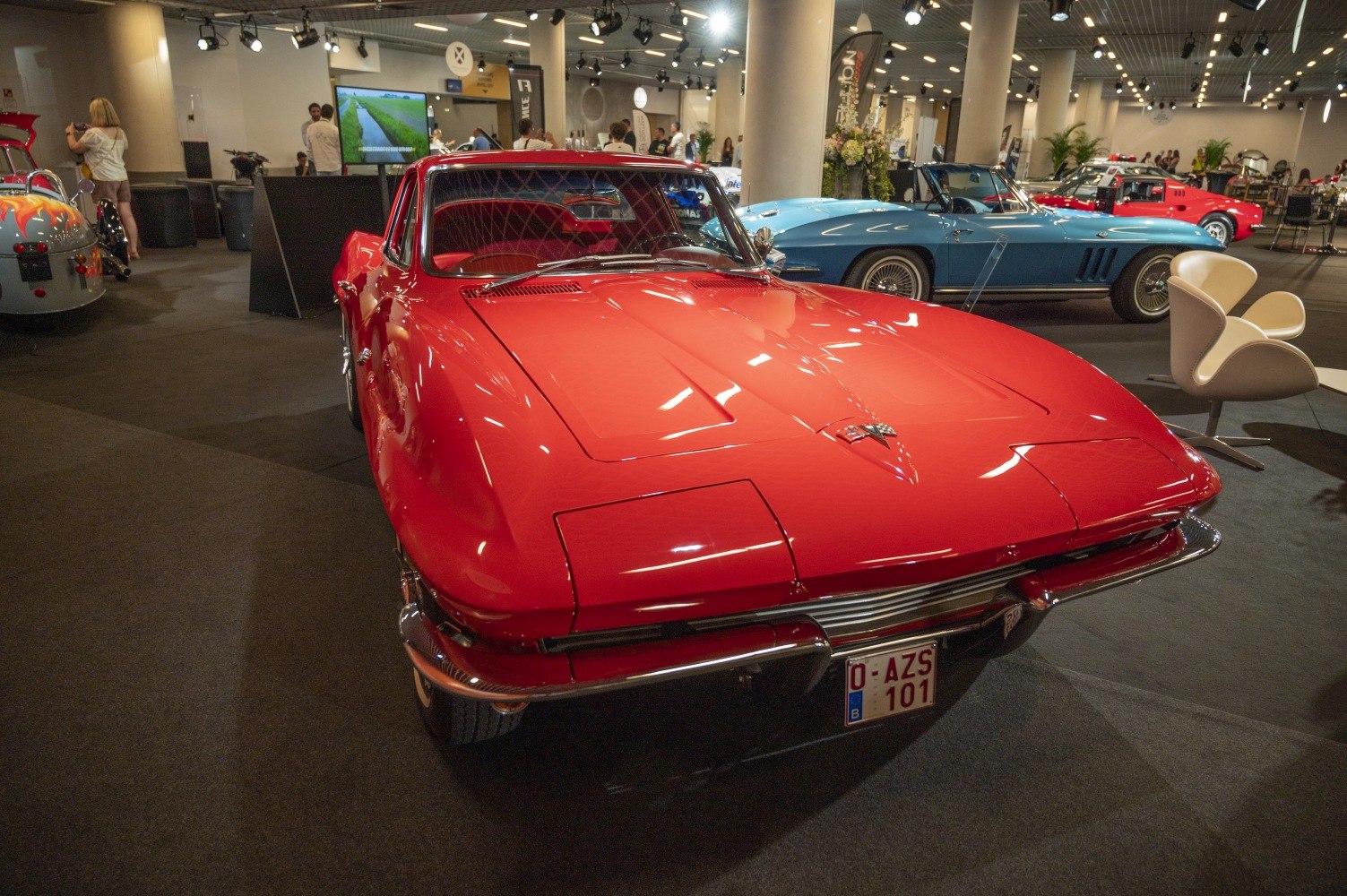 Streamlined front view with pop-up headlights and chrome bumper.