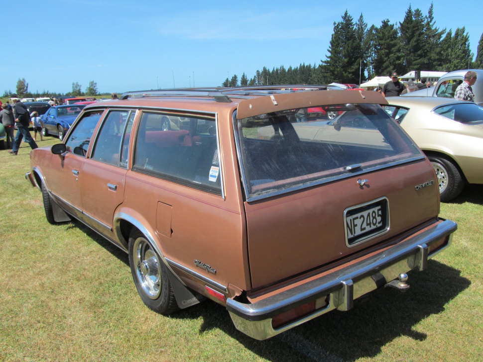 Rear three-quarter view of a vintage 1980s station wagon with elongated body and rear hatch.