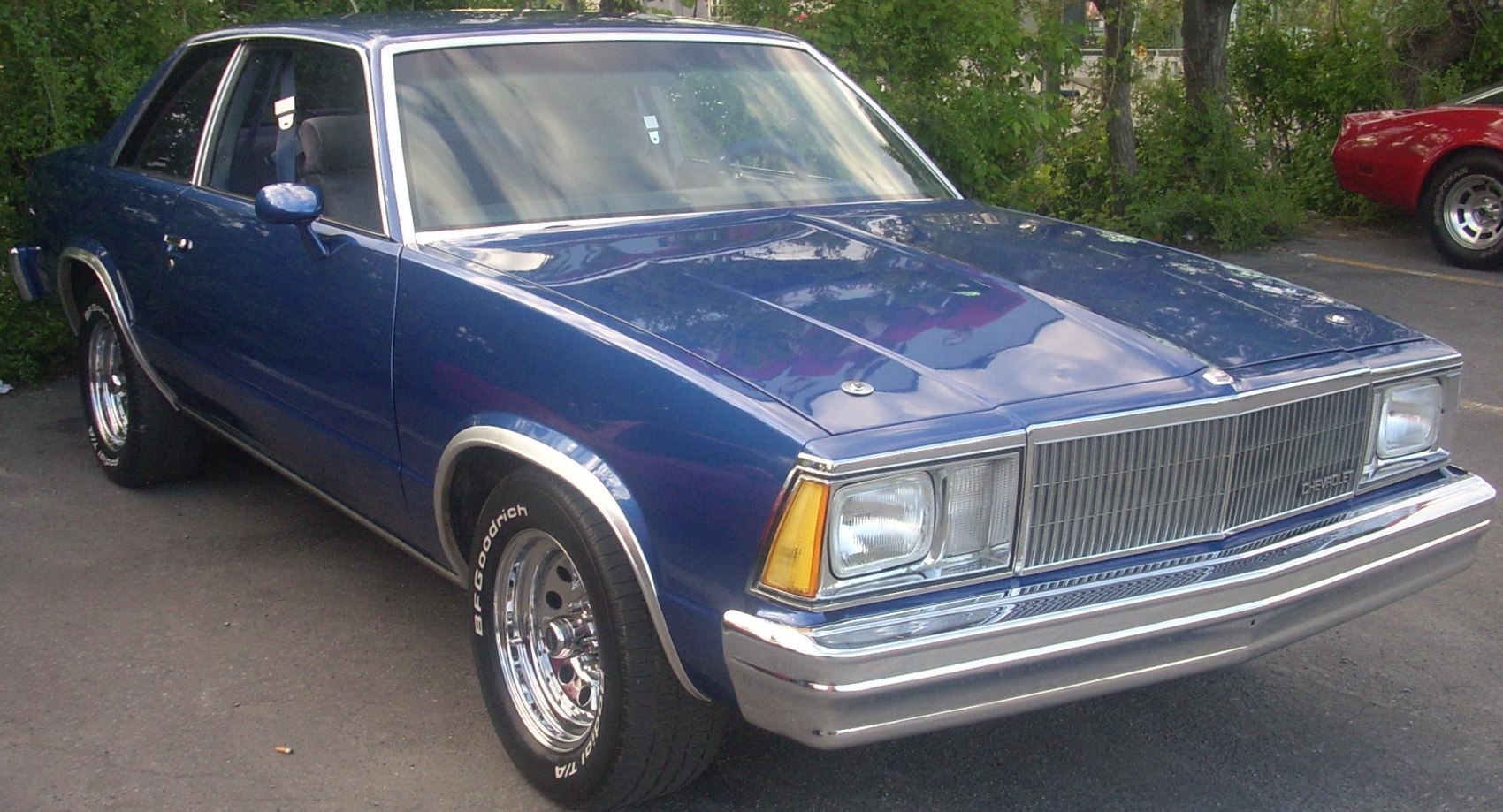 1970s muscle sedan with chrome wheels and distinct front grille