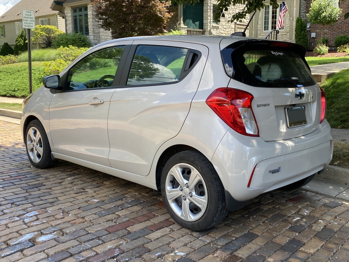 Rear side view of compact hatchback with modern tail lights and alloy wheels