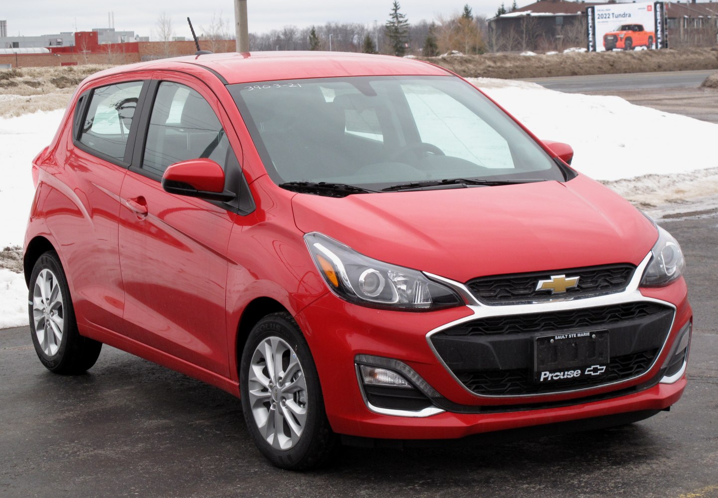 Front three-quarter view showing headlights and grille design