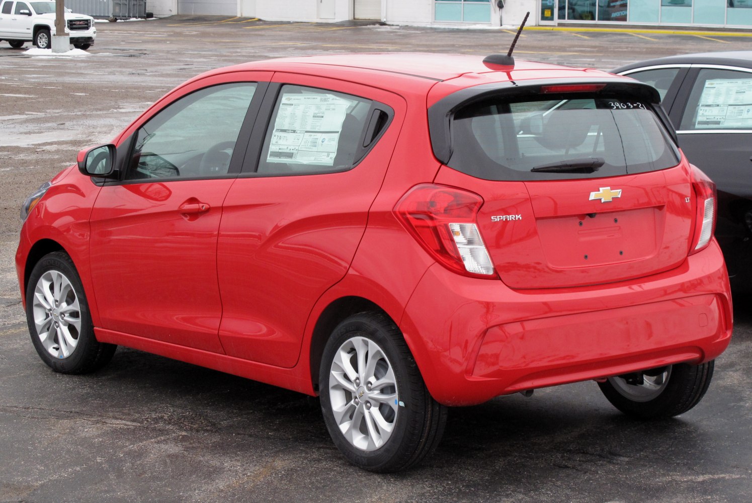 Compact red hatchback rear with distinctive tail lights and rear window