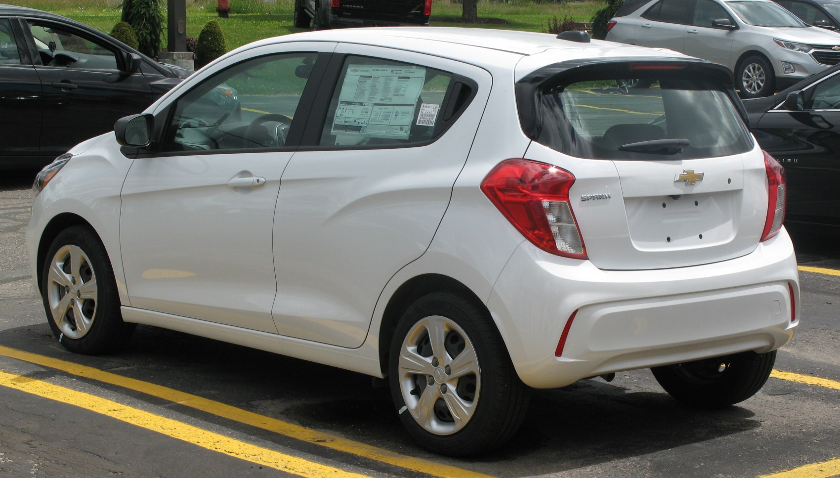 White hatchback rear and side view with distinct tail lights and small alloy wheels