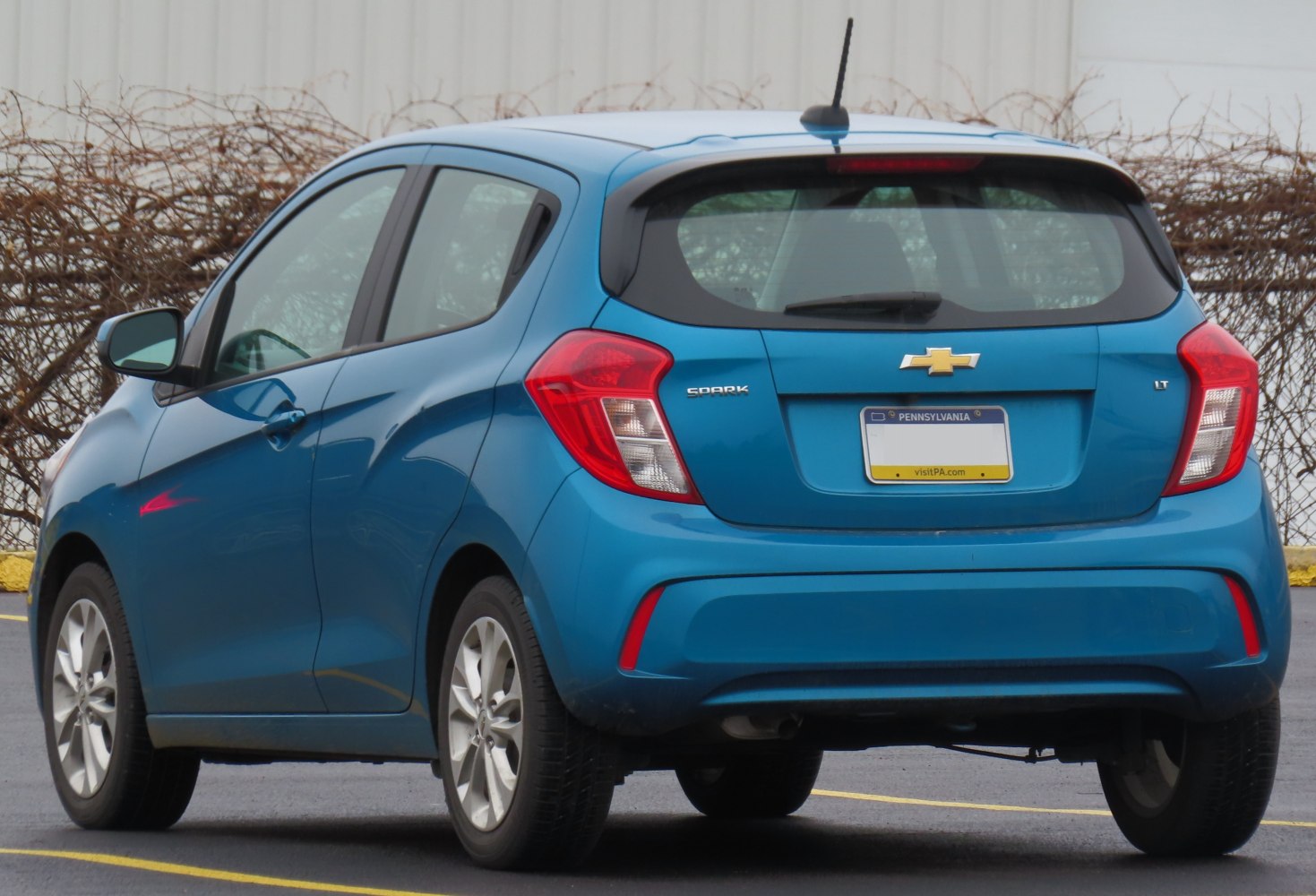 Rear view of compact hatchback with distinctive tail lights and rear window wiper