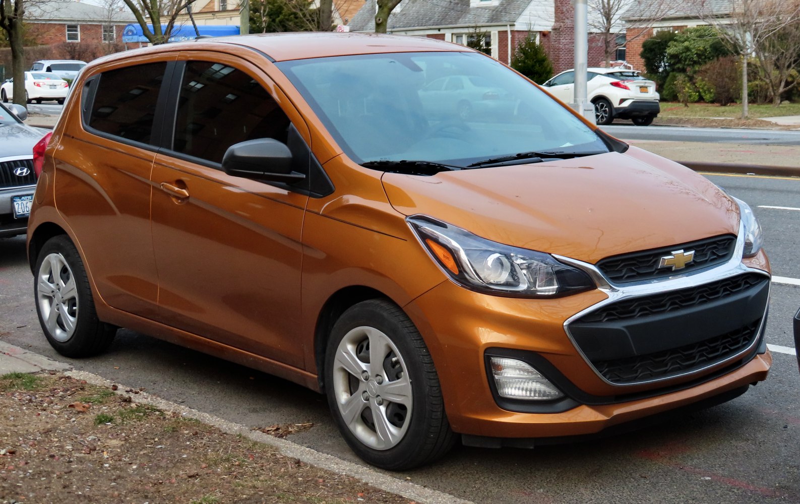 Front and side profile of compact hatchback with distinctive grille and headlight design