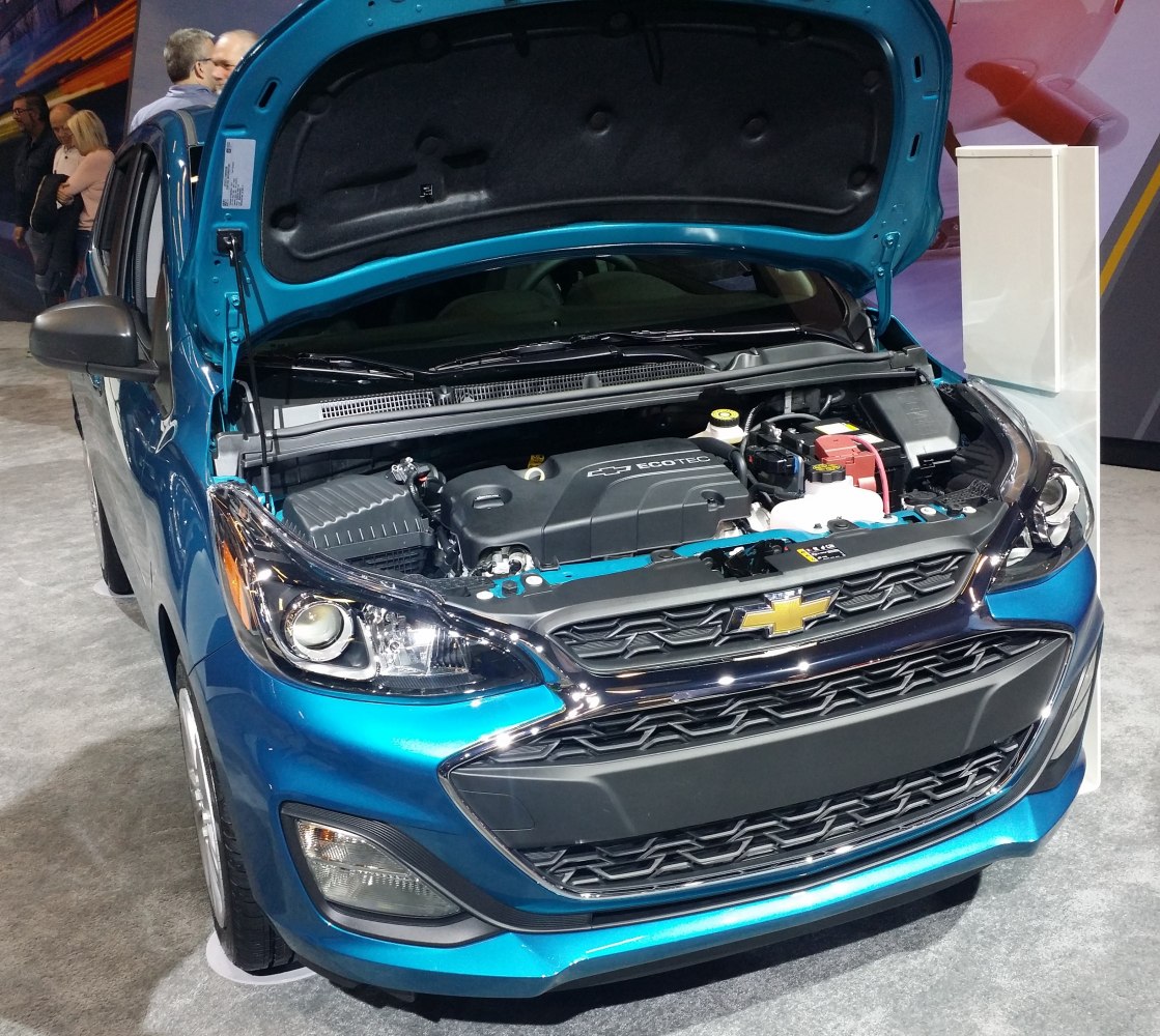 Open engine bay and front exterior of a compact hatchback