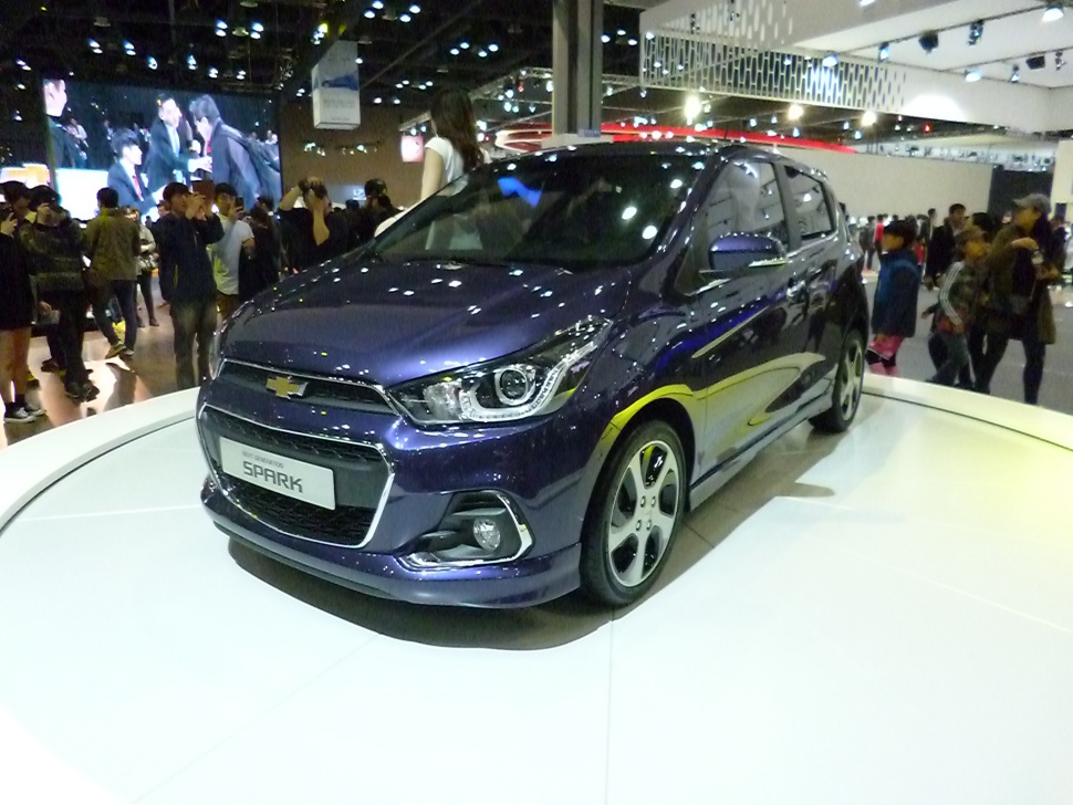 Front and side view of a compact hatchback with distinctive headlights and sporty wheels