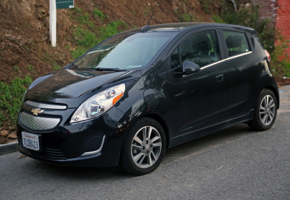 Front side view of a compact electric hatchback with aerodynamic grille and modern headlights.