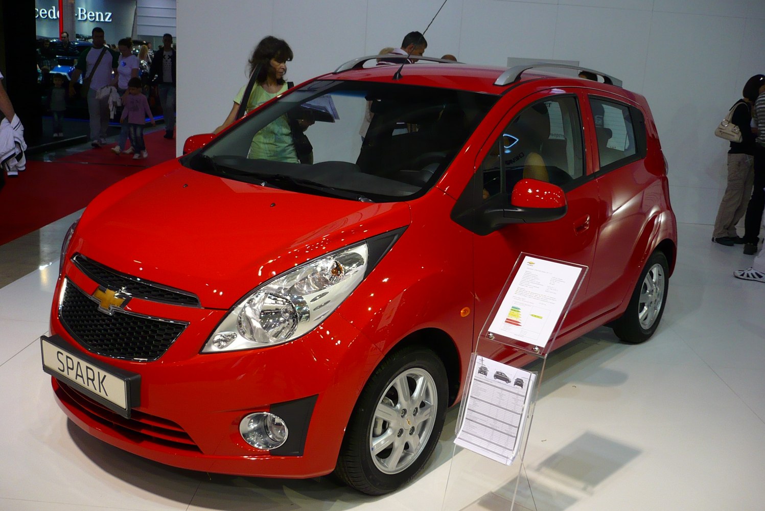 Red hatchback with sharp headlights and distinct front grille