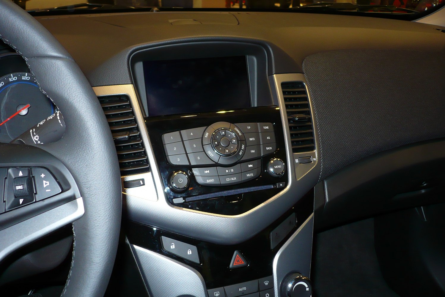 Dashboard and infotainment controls with steering wheel and air vents