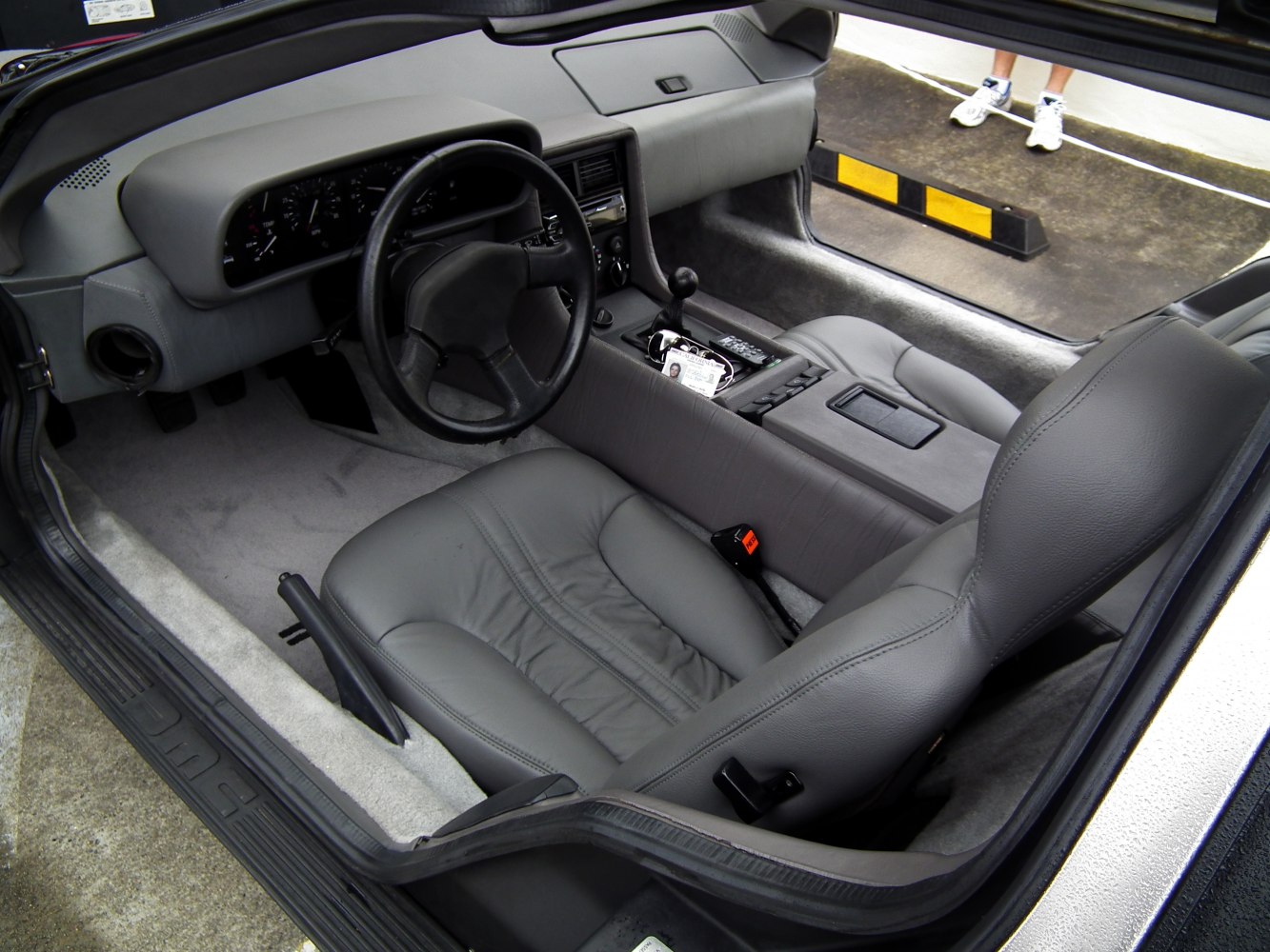 Gray leather seats and dashboard with steering wheel and manual gear shift