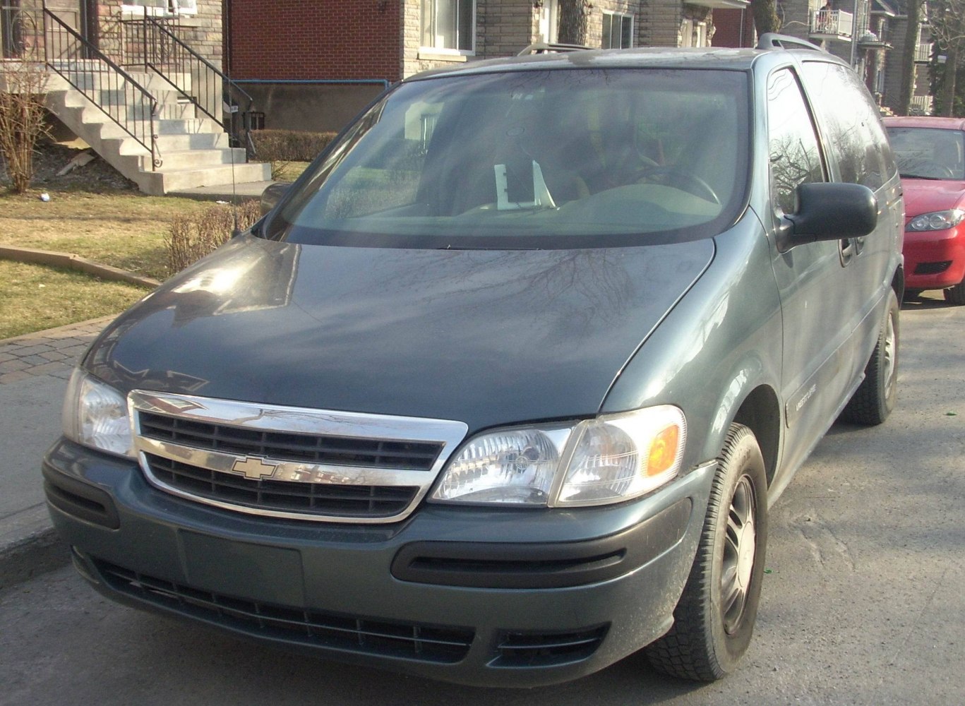 Minivan front view with grille, headlights, and side mirror