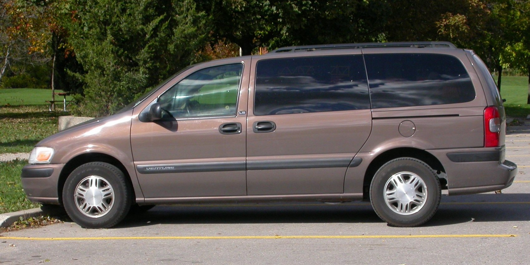 Side profile of a minivan with sliding door and tinted windows