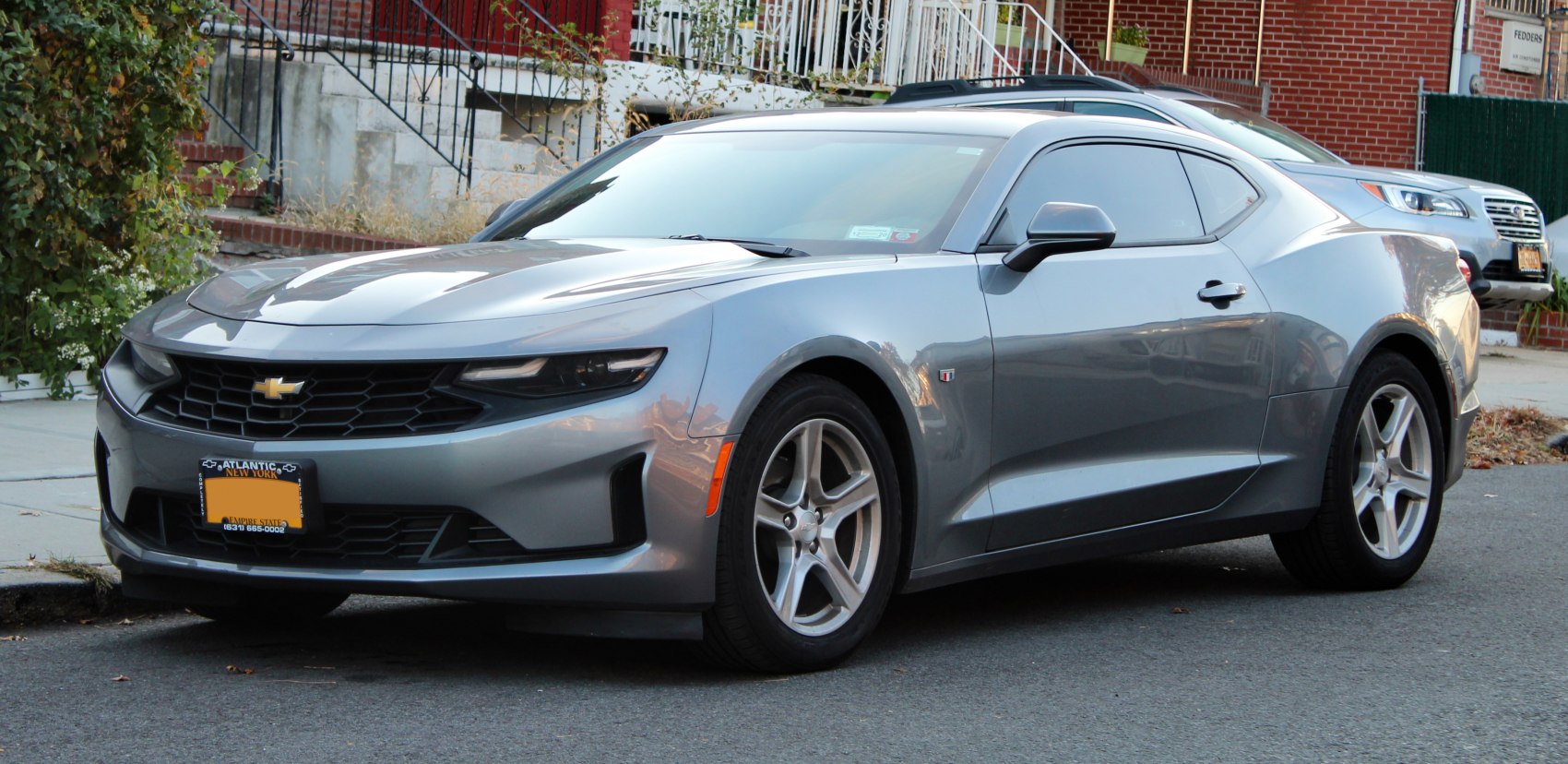 Front three-quarter view with aggressive headlights and sporty coupe body.