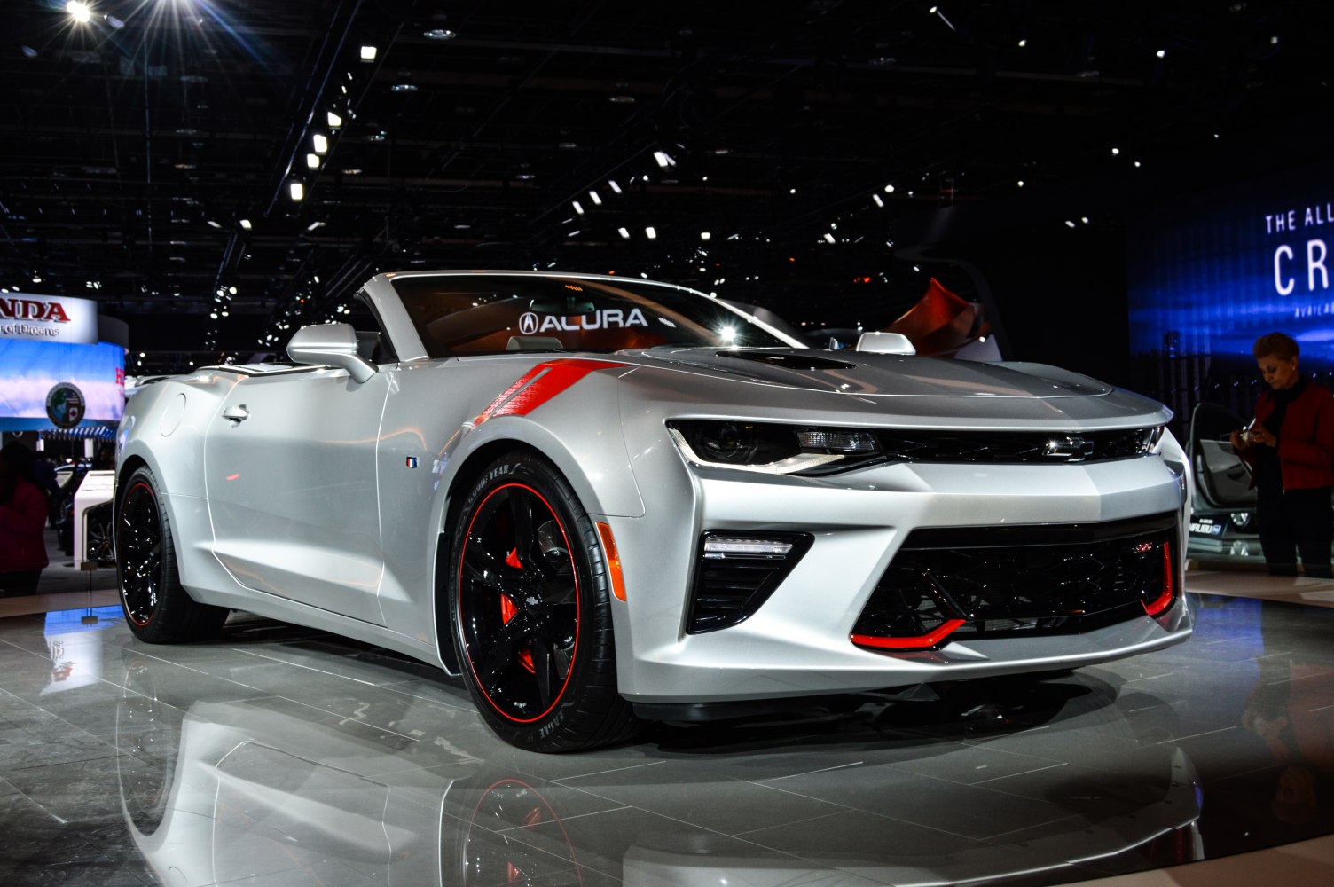 Convertible sports car with custom black and red alloy wheels and aggressive front fascia.
