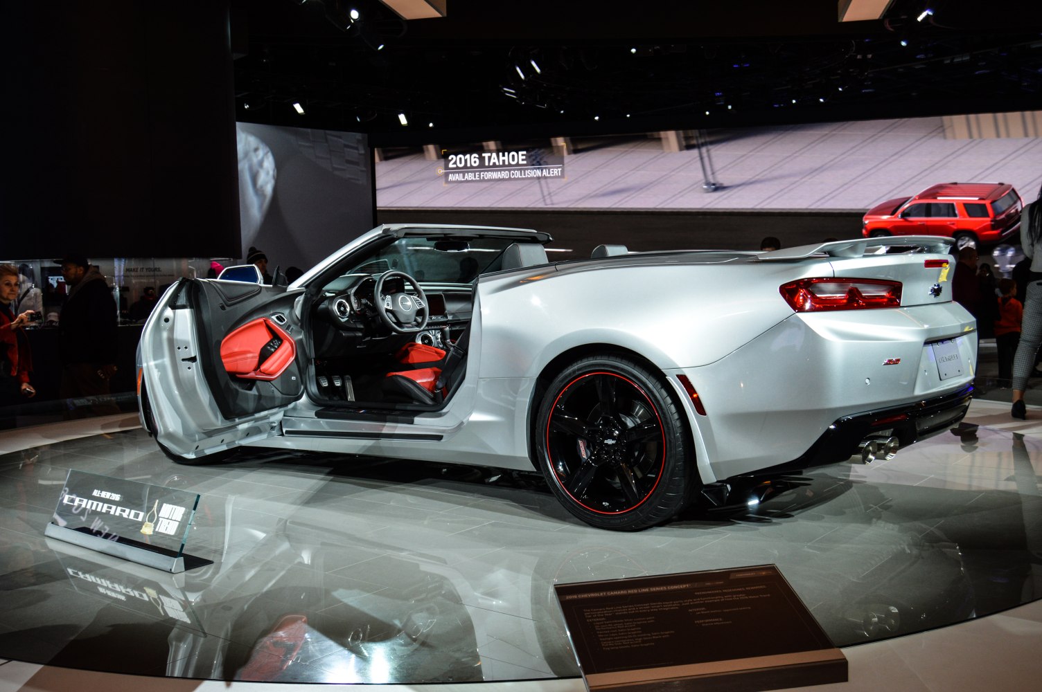 Convertible sports car with red interior and black wheels with red trim