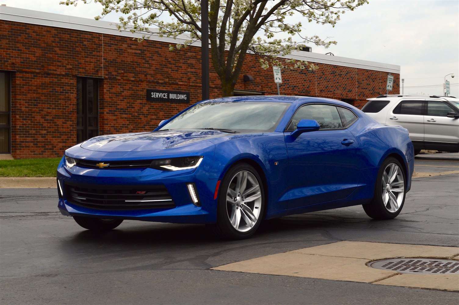 Sleek blue sports coupe front-side view with alloy wheels