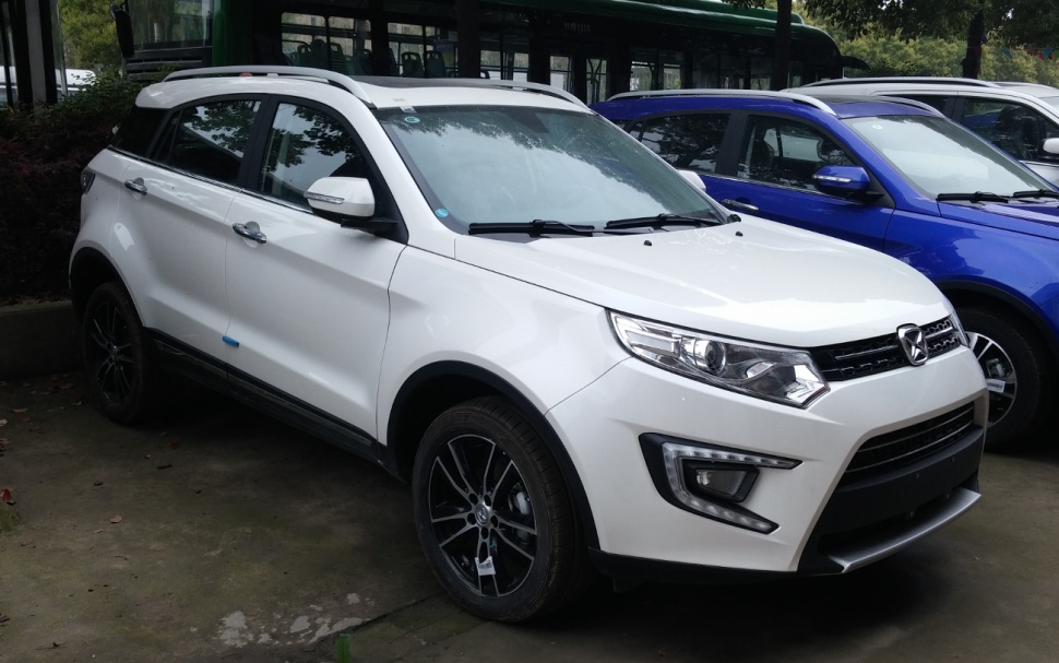 Front side view of an SUV with detailed headlights and alloy wheels