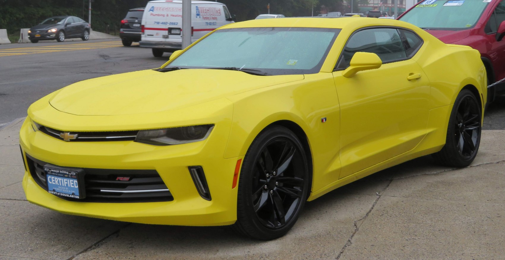 Bright yellow modern muscle coupe with black wheels and aerodynamic body