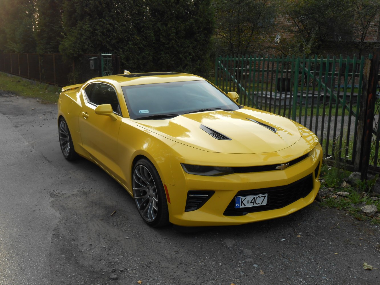 Yellow coupe with hood vents and sporty alloy wheels