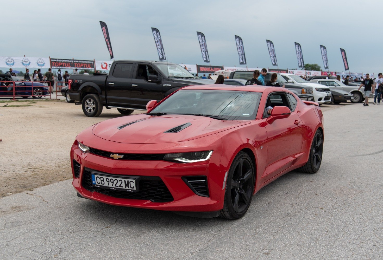 Red sports coupe with aggressive front and black wheels