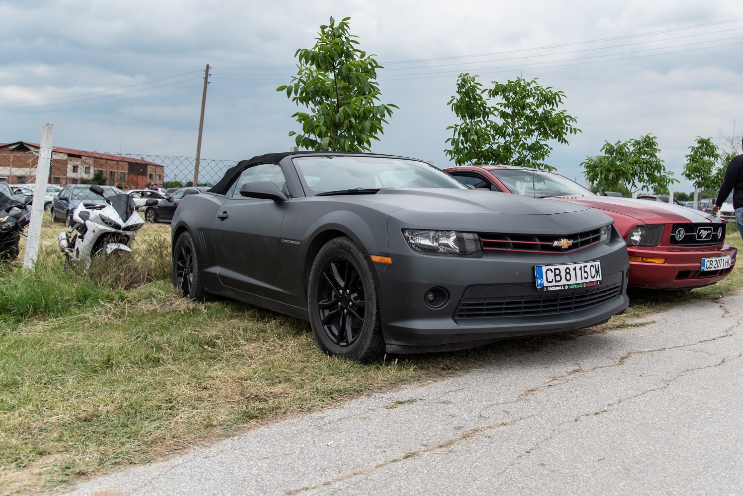 Matte gray sports convertible with black wheels and sharp headlights