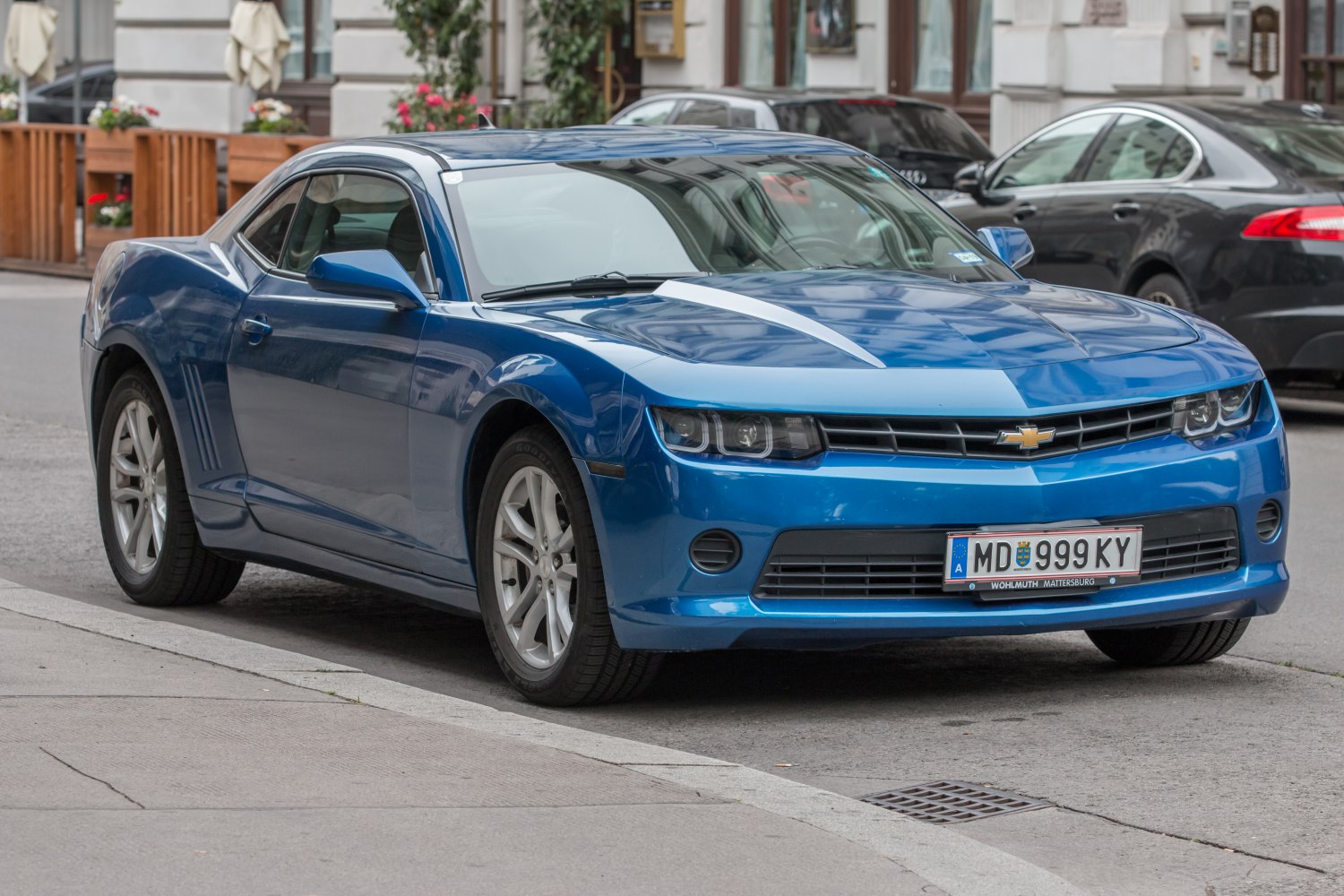 Aggressive front grille and headlights of a blue sports coupe