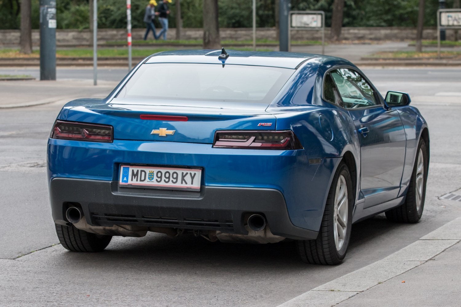 Rear view with RS badge, dual exhaust, and distinct tail lights