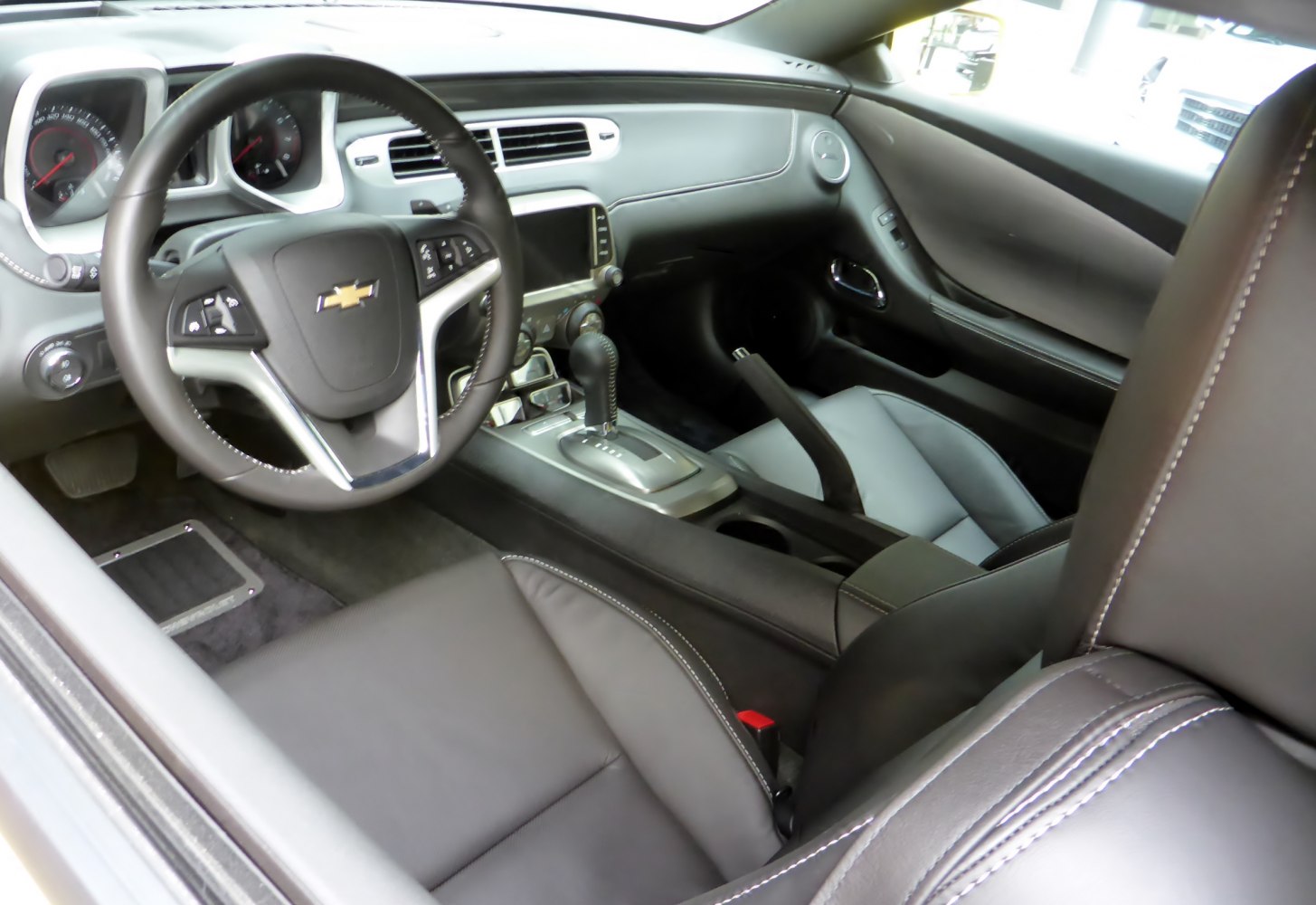 Sleek car dashboard and leather seats with automatic gearshift