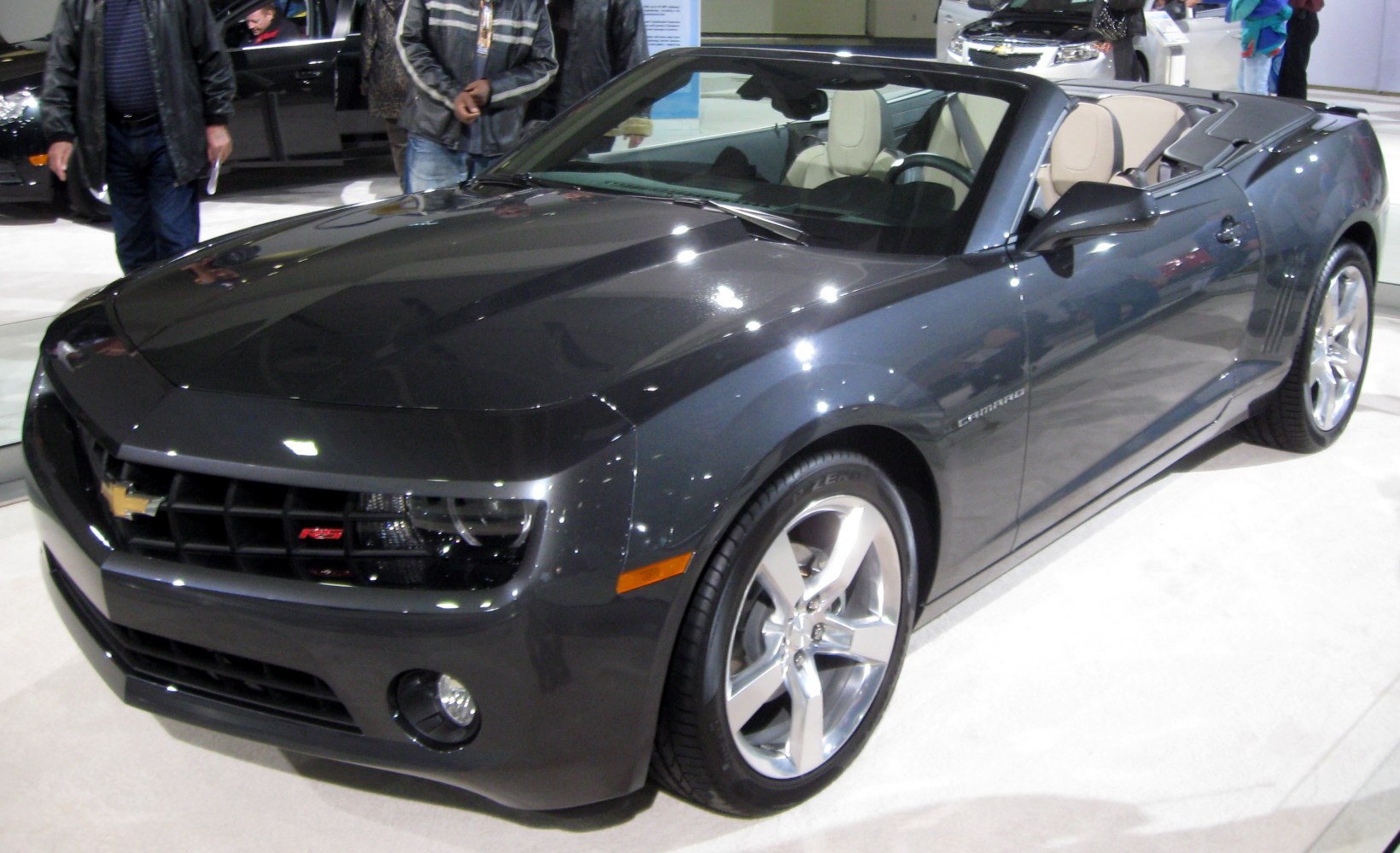 Front and side view of convertible with open roof and alloy wheels