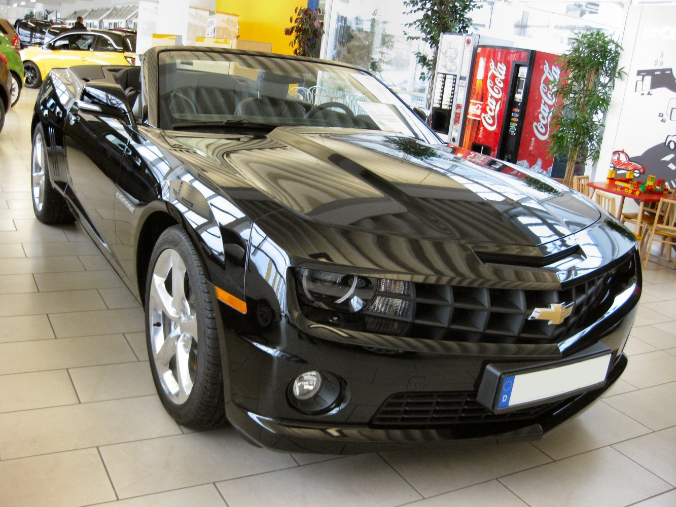 Black convertible front view with aggressive grille and modern headlights
