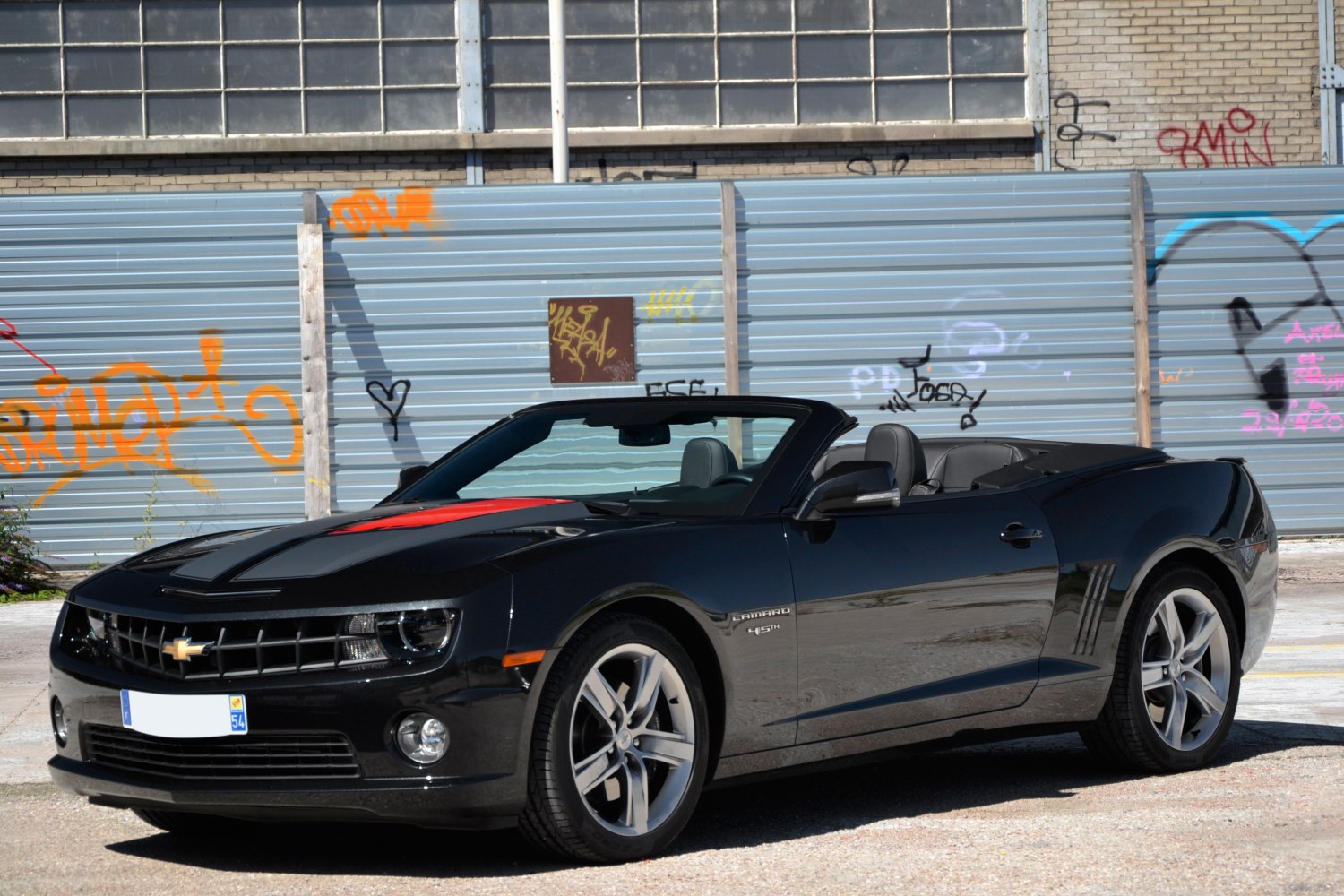 Black convertible with red hood stripe and alloy wheels