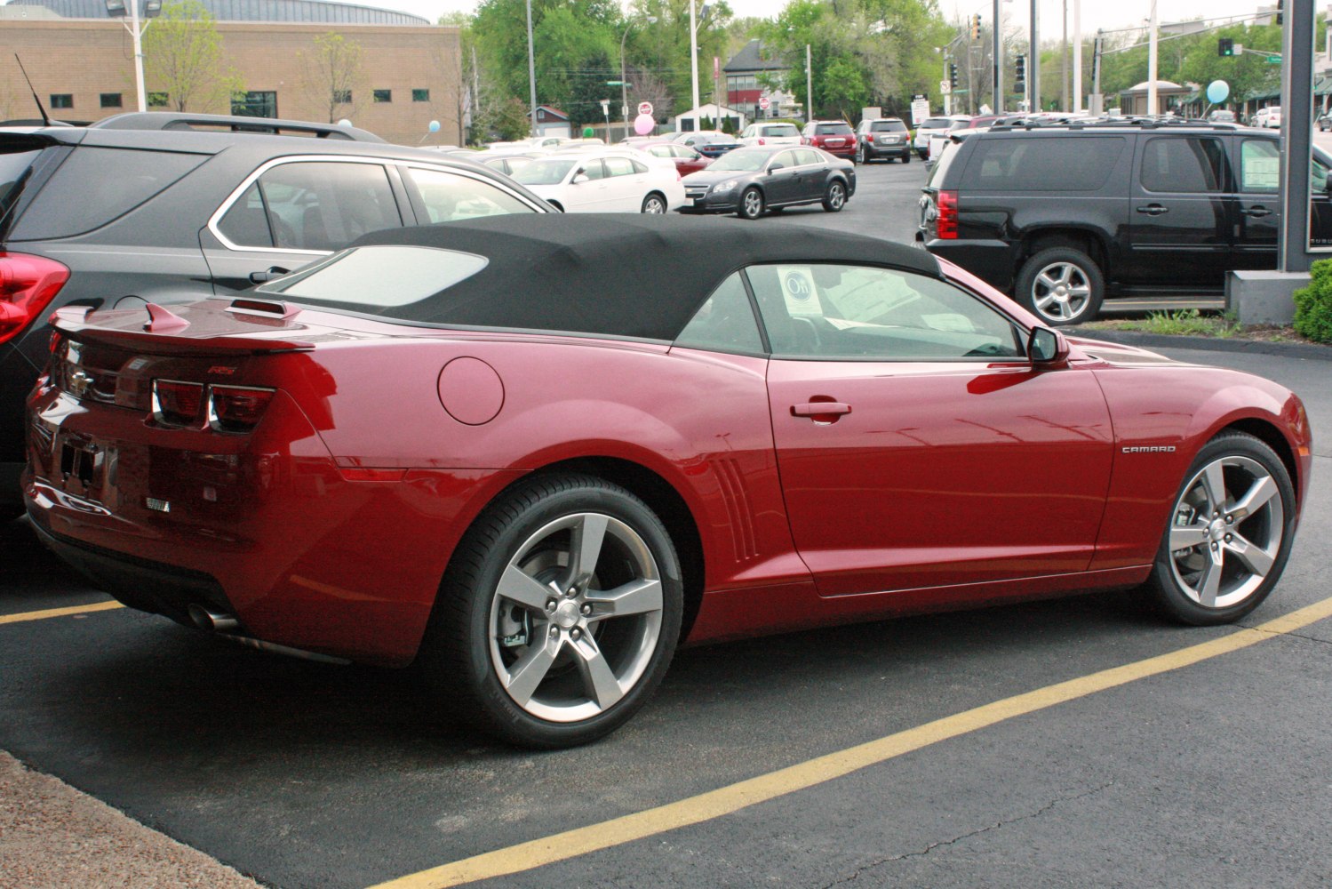 Red convertible with soft black fabric top and silver alloy wheels