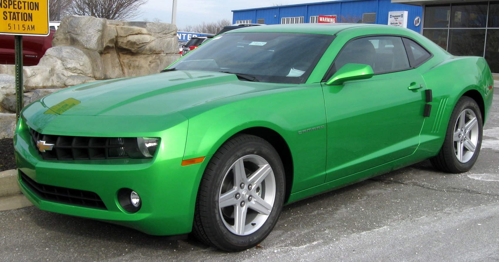 Bright green sporty coupe with front grille and alloy wheels