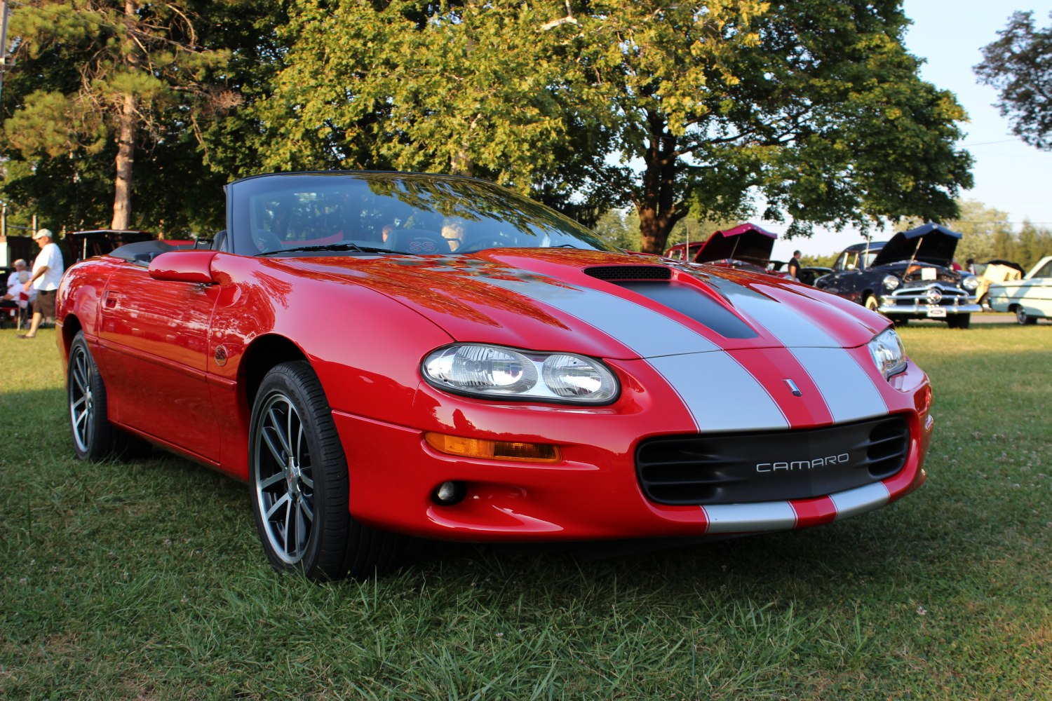 Red convertible with silver racing stripes and black alloy wheels