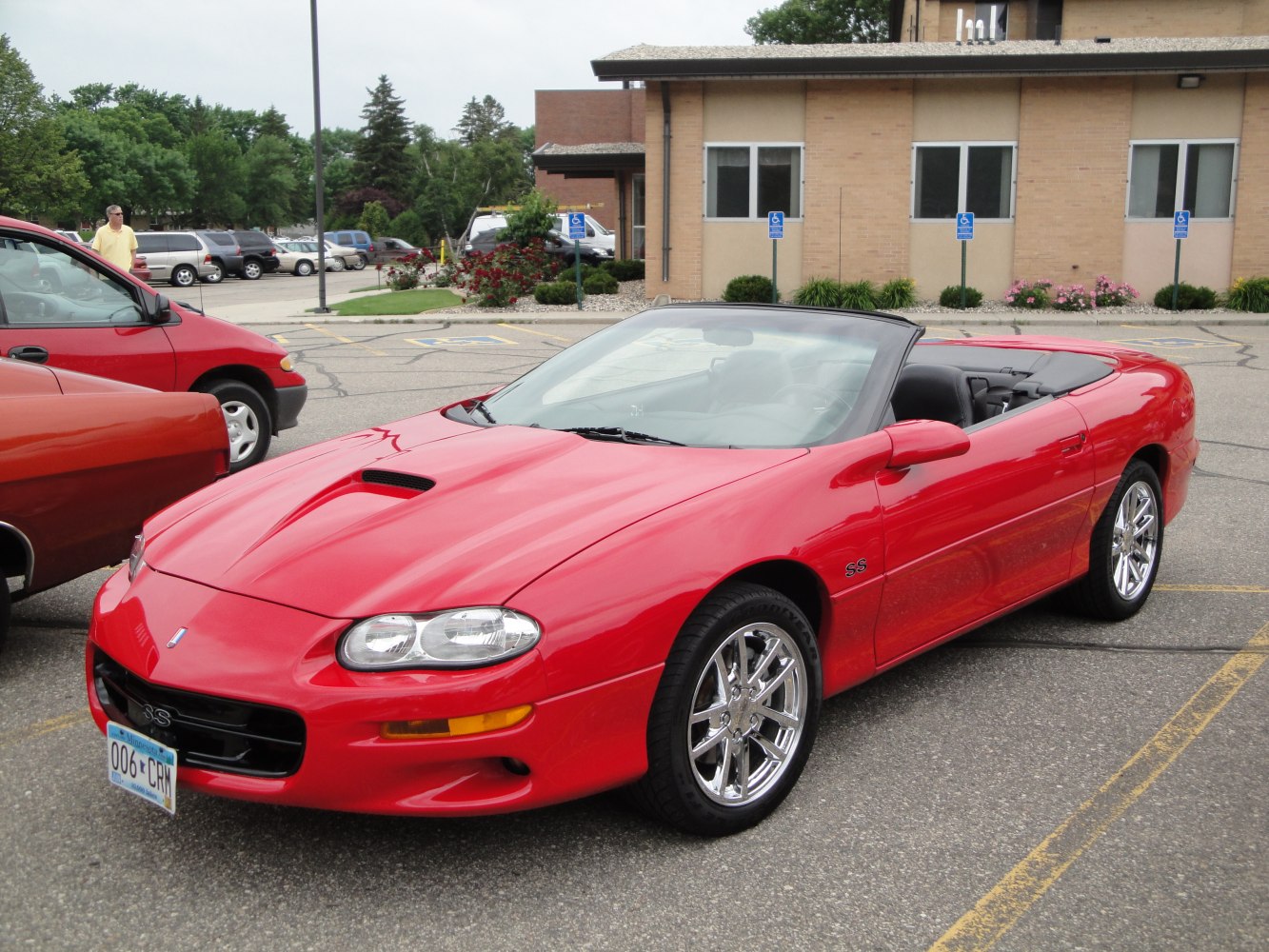 Red convertible with hood scoop and chrome wheels