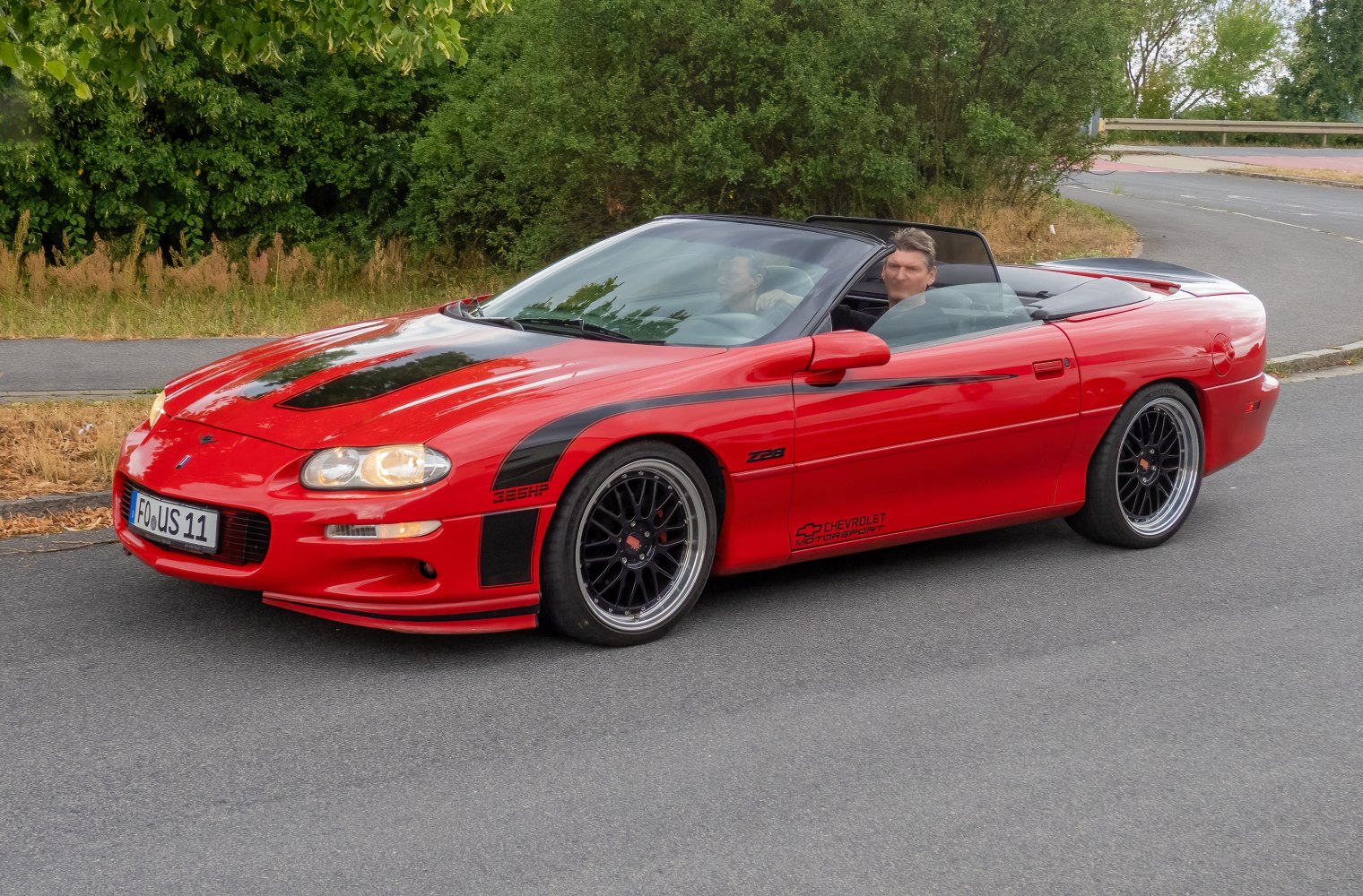 Red convertible with black racing stripes and sporty wheels