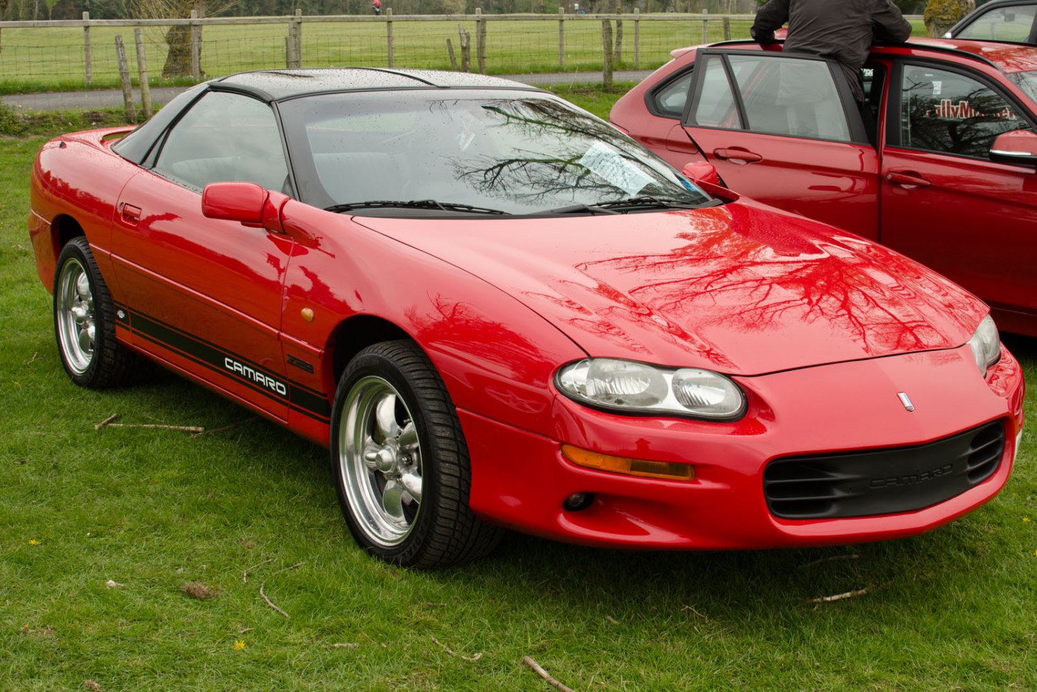 Red Chevrolet Camaro IV facelift with targa roof and polished wheels