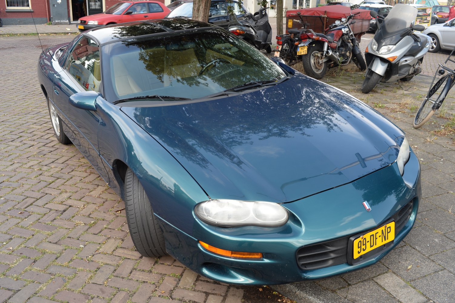 Front view of a sports car highlighting headlights and aerodynamic hood.