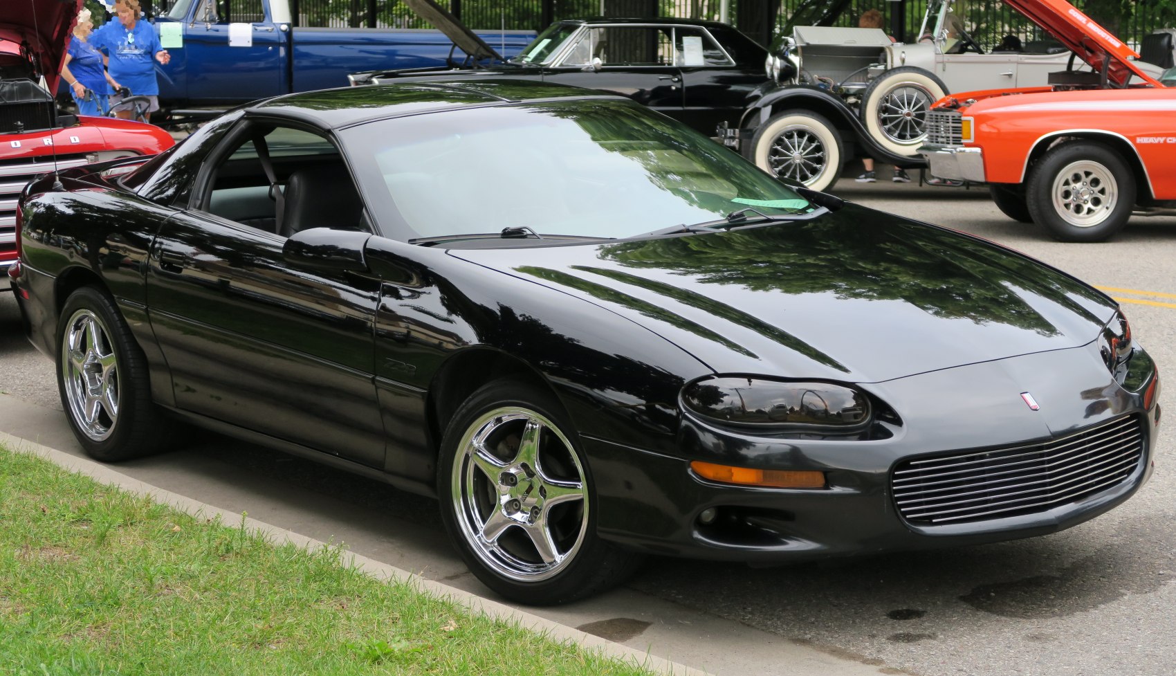 Black sports coupe with polished alloy wheels and distinct front grille