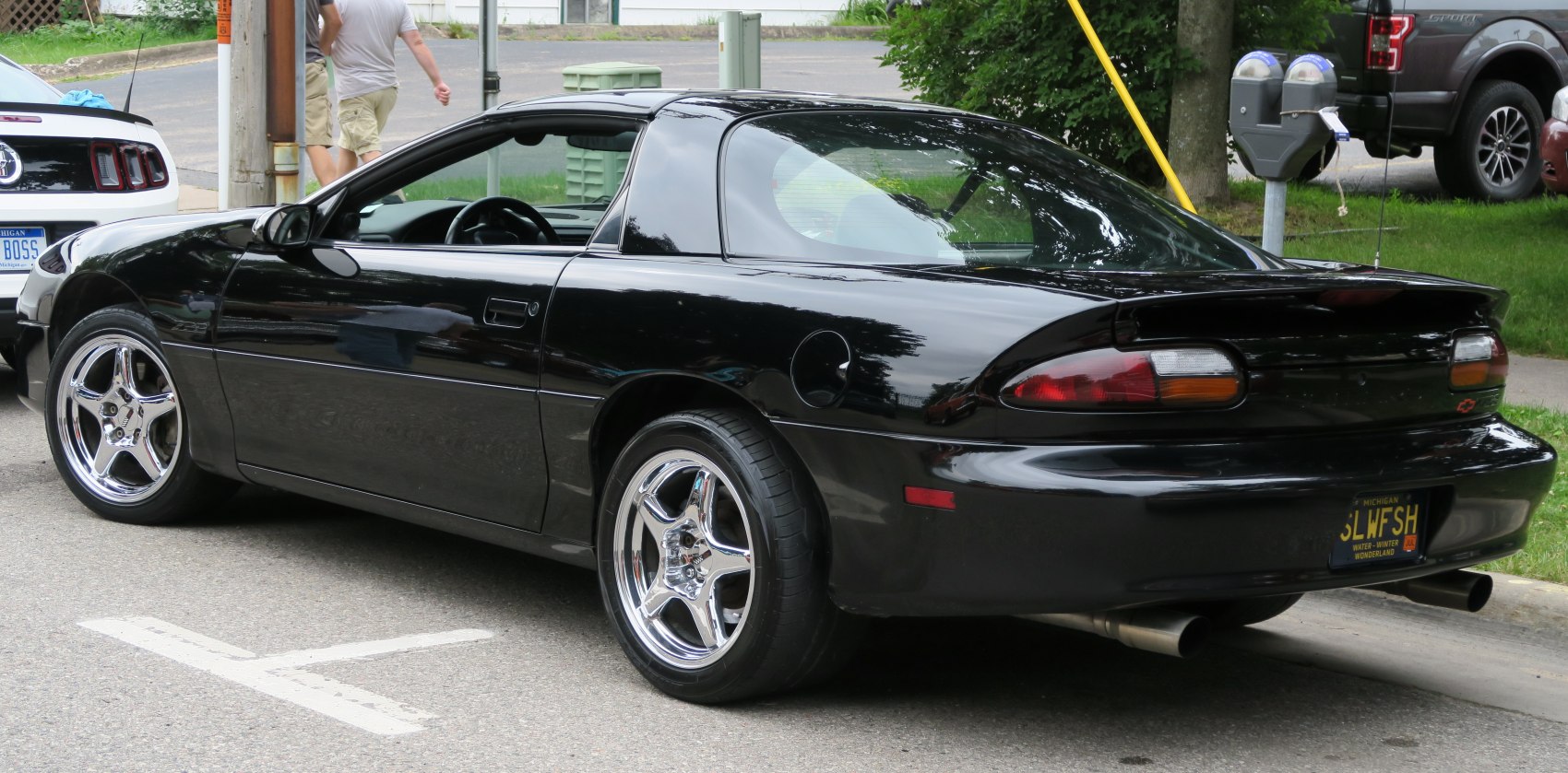 Rear side view of 1998 Chevrolet Camaro IV facelift with chrome wheels and dual exhaust