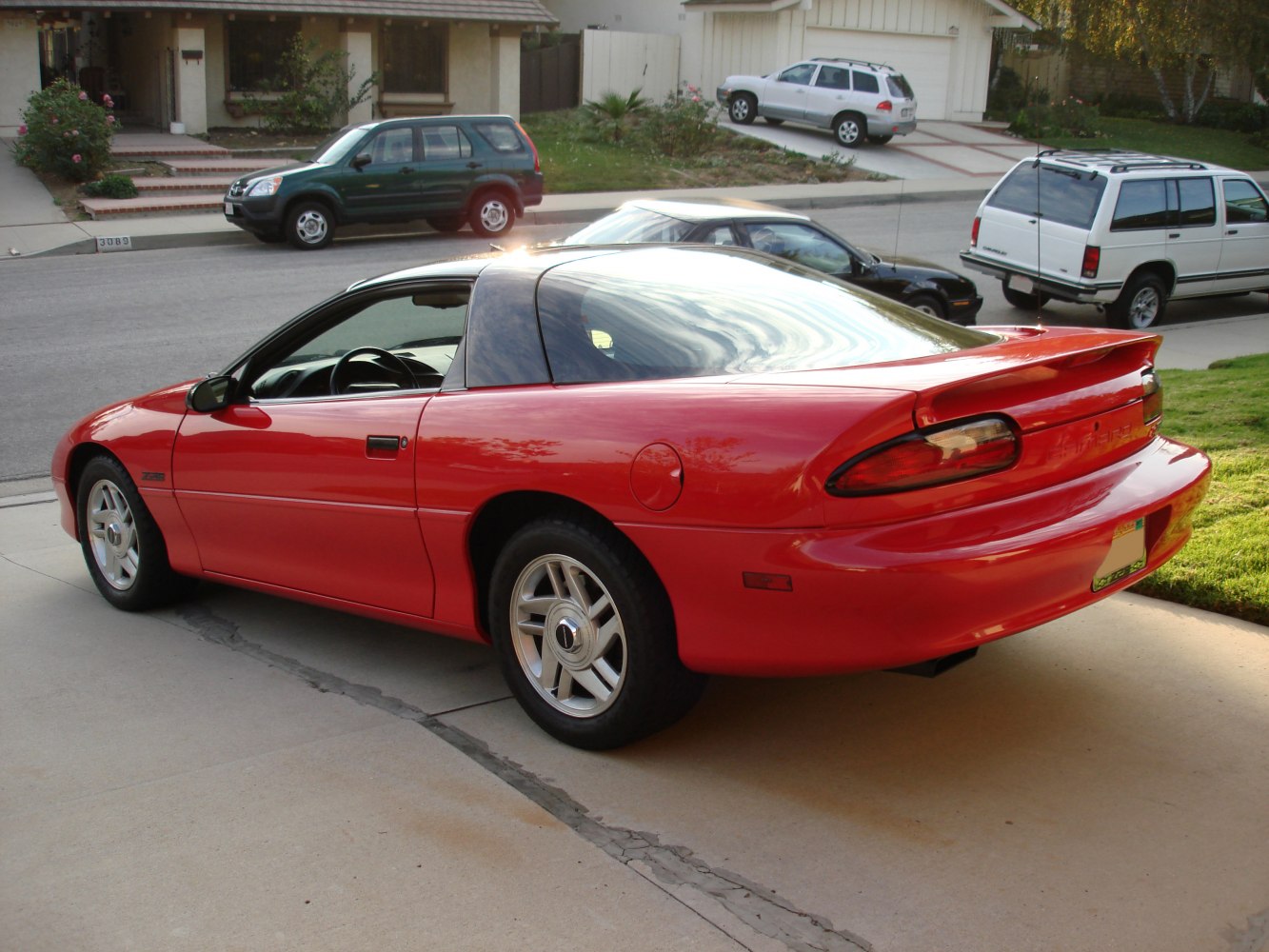 Red sports coupe with rear spoiler and tinted glass roof