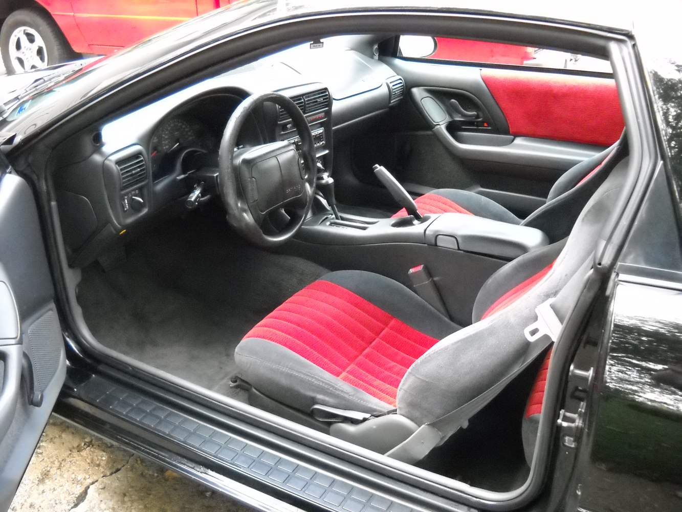 Red and black seats, dashboard, manual handbrake