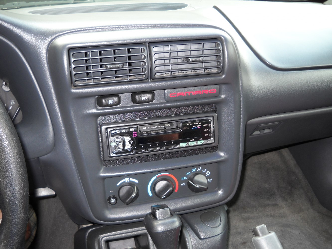 Close-up of car dashboard with air vents, stereo, and climate controls